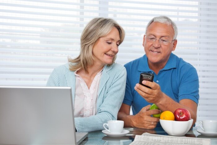 A couple reviewing their Medicare options on a laptop and phone