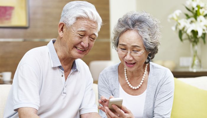 A couple reviewing Medicare Advantage plan options on a phone